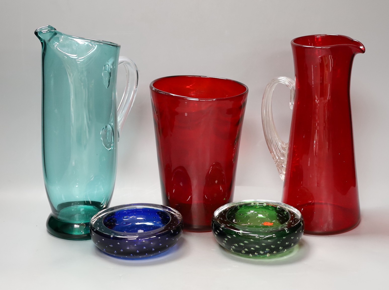 A selection of art glass, probably Whitefriars to include two jugs, a vase and two dishes suffused with bubbles. Tallest 29cm